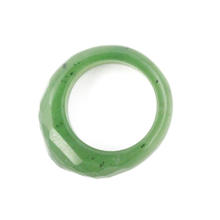Side view of green faceted band ring showing geometric facets along the outer edge