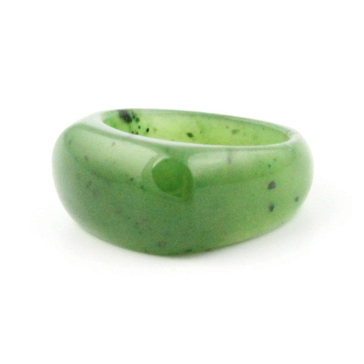 Saddle top green jade band ring with a thick rounded profile on a white background