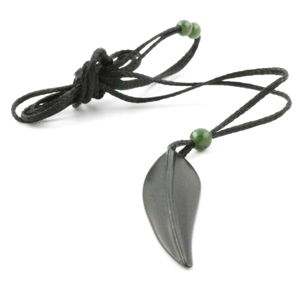 Grey leaf pendant on a black cord necklace with small green beads