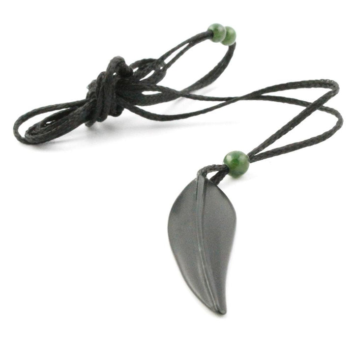 Grey leaf pendant on a black cord necklace with small green beads