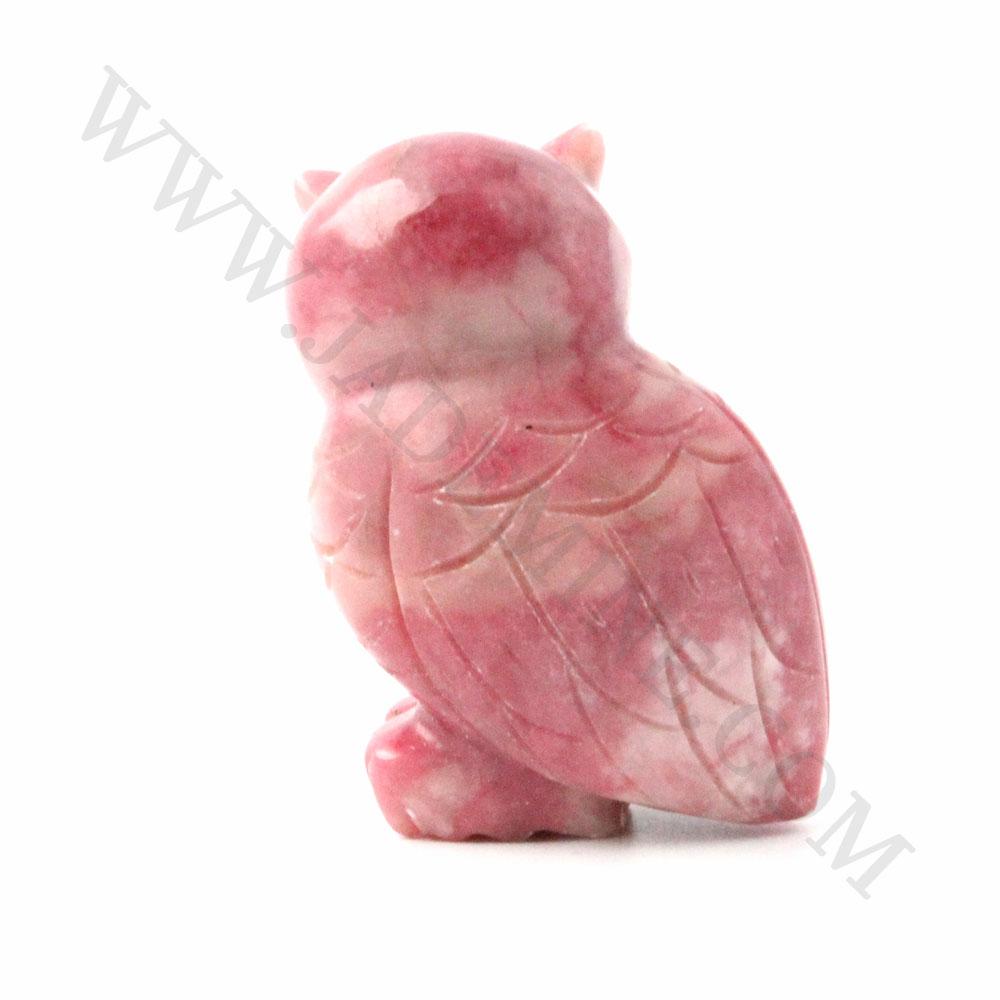 Pink rhodonite owl figurine viewed from the side with a rounded head