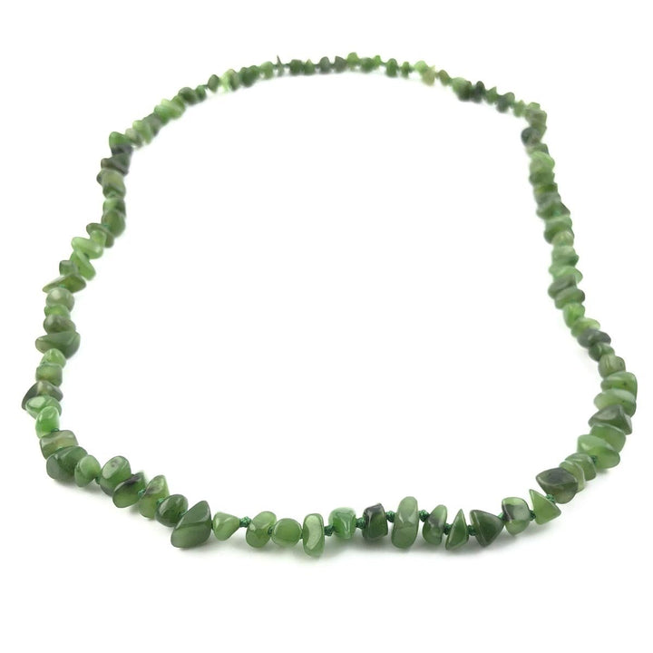 Green jade chip bead necklace arranged in a loose circular loop.