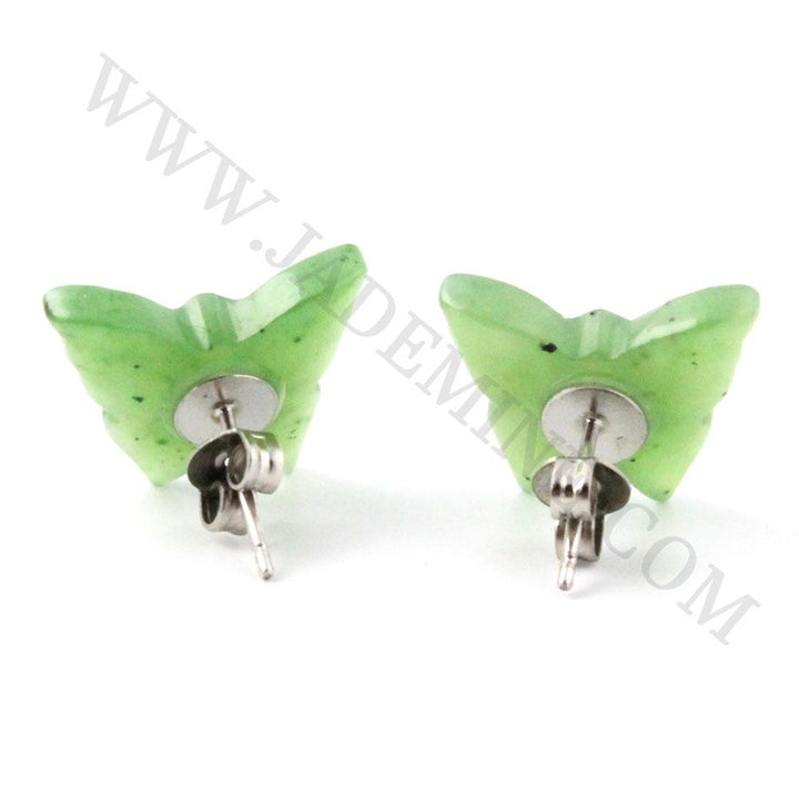 Pair of green butterfly stud earrings with silver posts photographed on a white background.