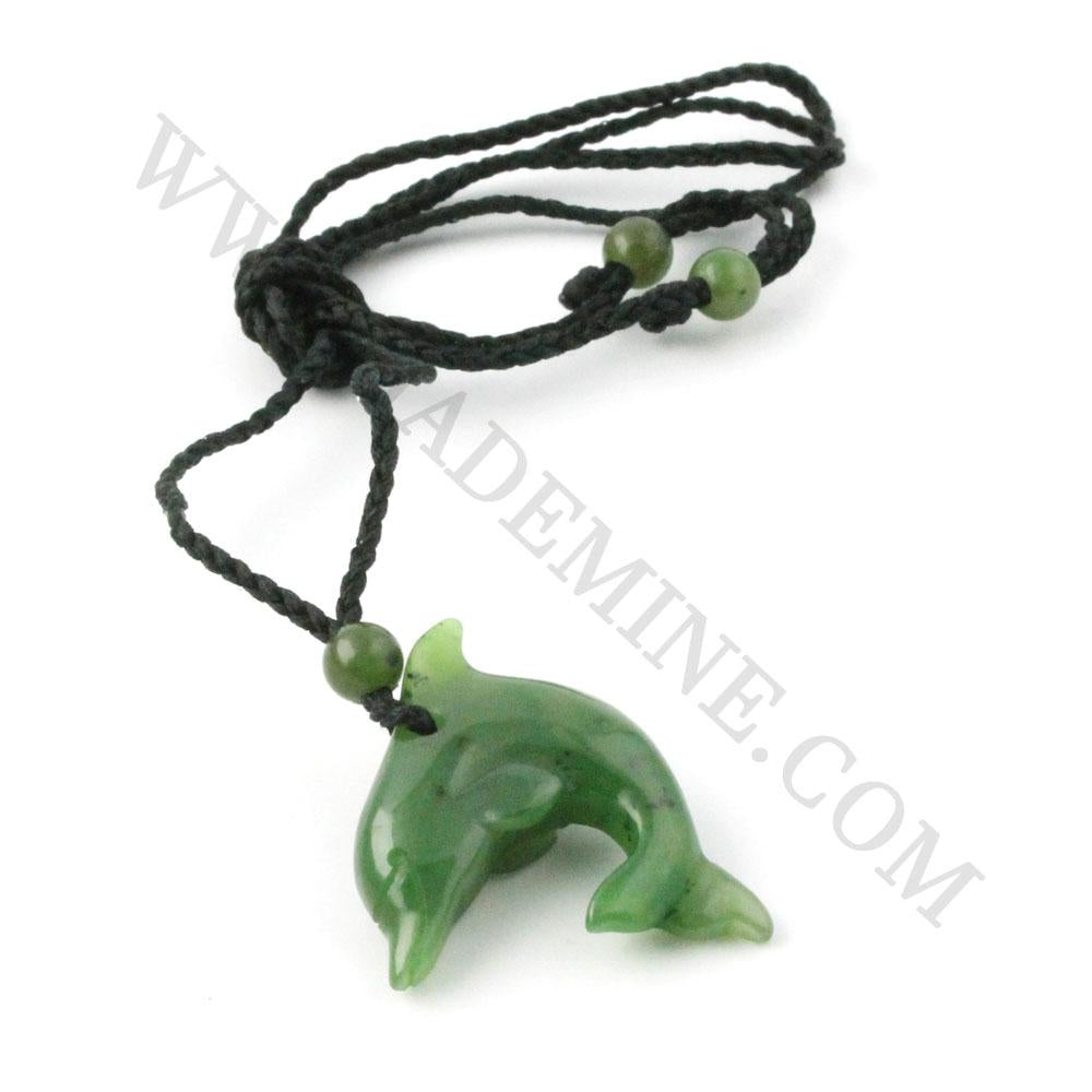 Green jade dolphin pendant on a black braided cord with green beads against a white background.