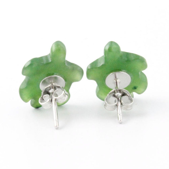 Front view of translucent green turtle shaped earrings with shell pattern against a white background