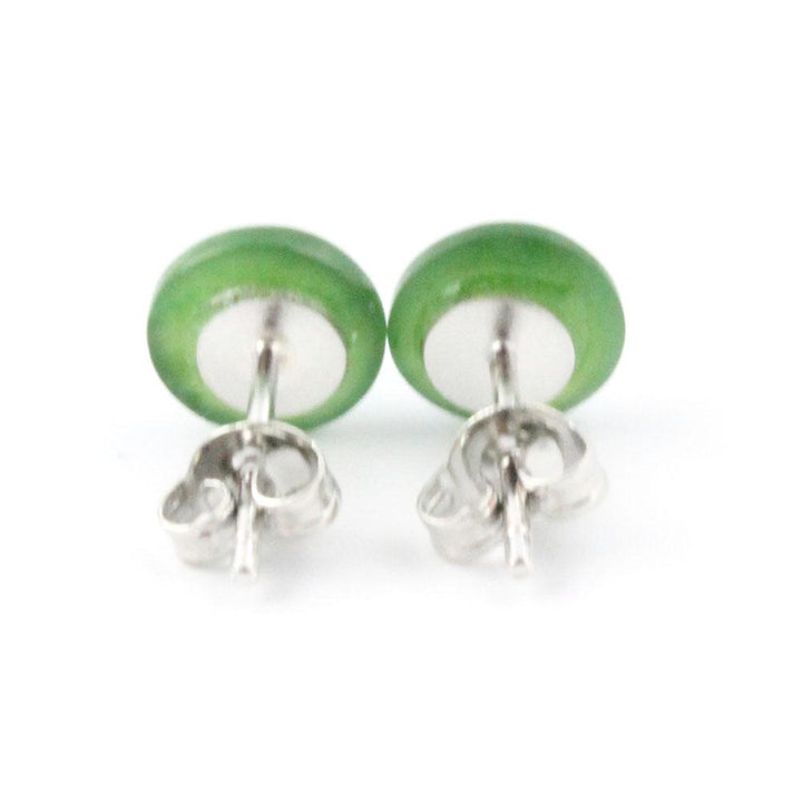 Close-up of jade flat stud earrings with green stones and silver butterfly backs.