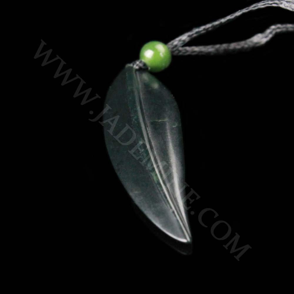 Leaf pendant on a black cord with a small green bead above a dark elongated leaf