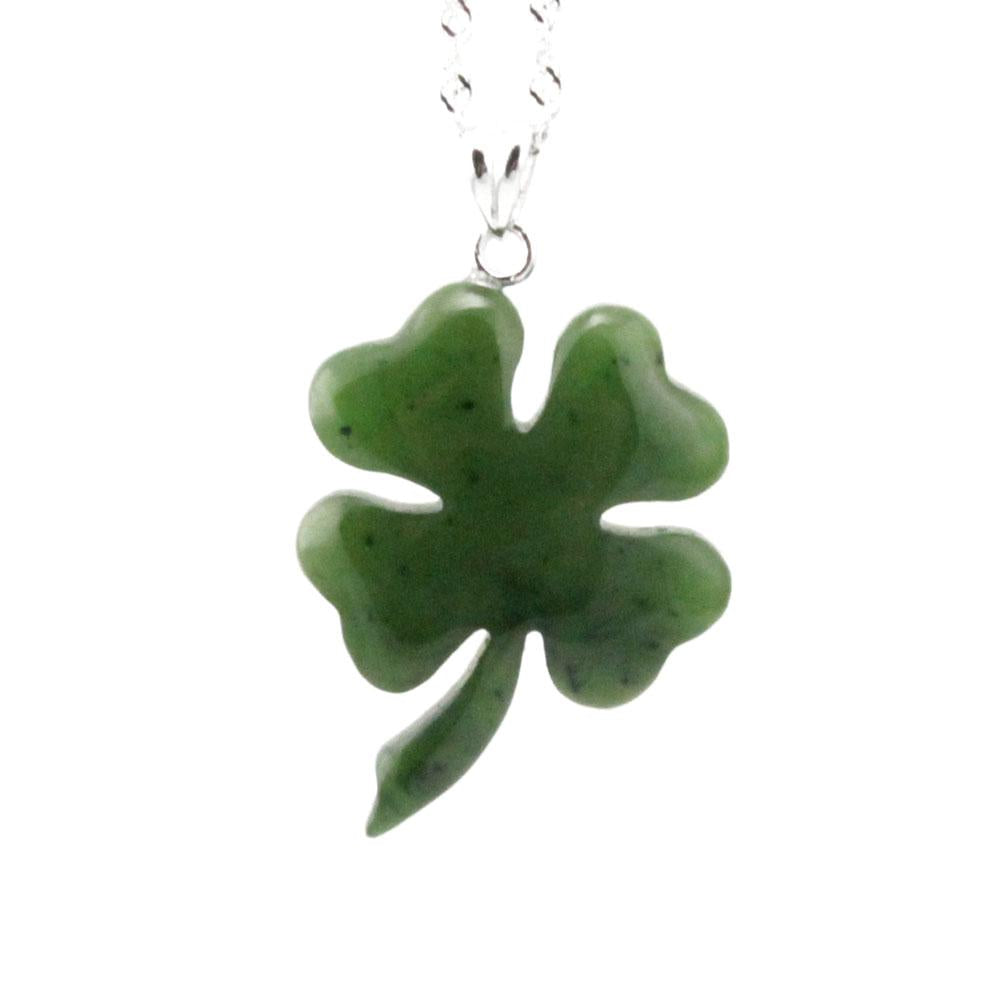 Green jade shamrock pendant hanging from a silver chain against a white background