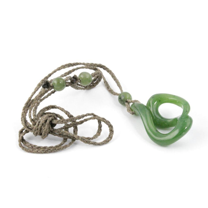 Jade pendant on a long braided cord with several round green beads.