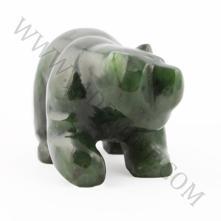 Green jade bear sculpture in a walking pose seen from the side