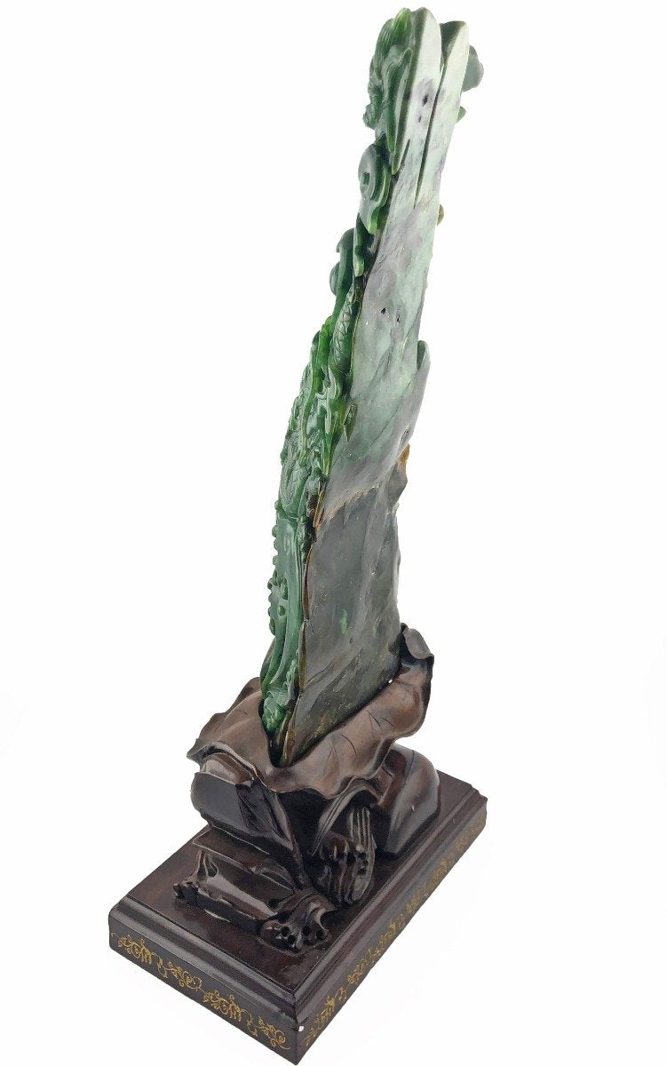 Tall jade dragon statue on a dark carved wooden base with gold trim.