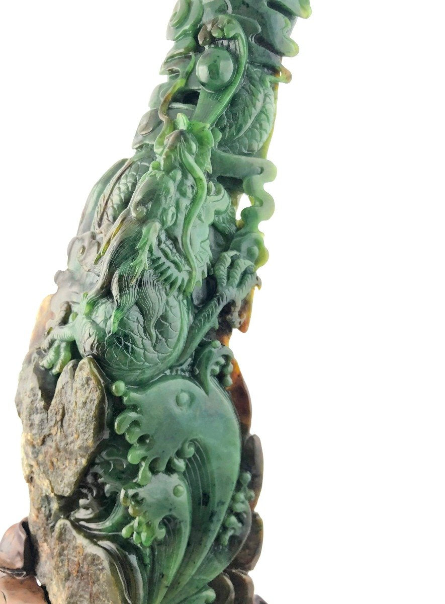 Close view of a green jade dragon entwined with rocks showing detailed scales and flowing form