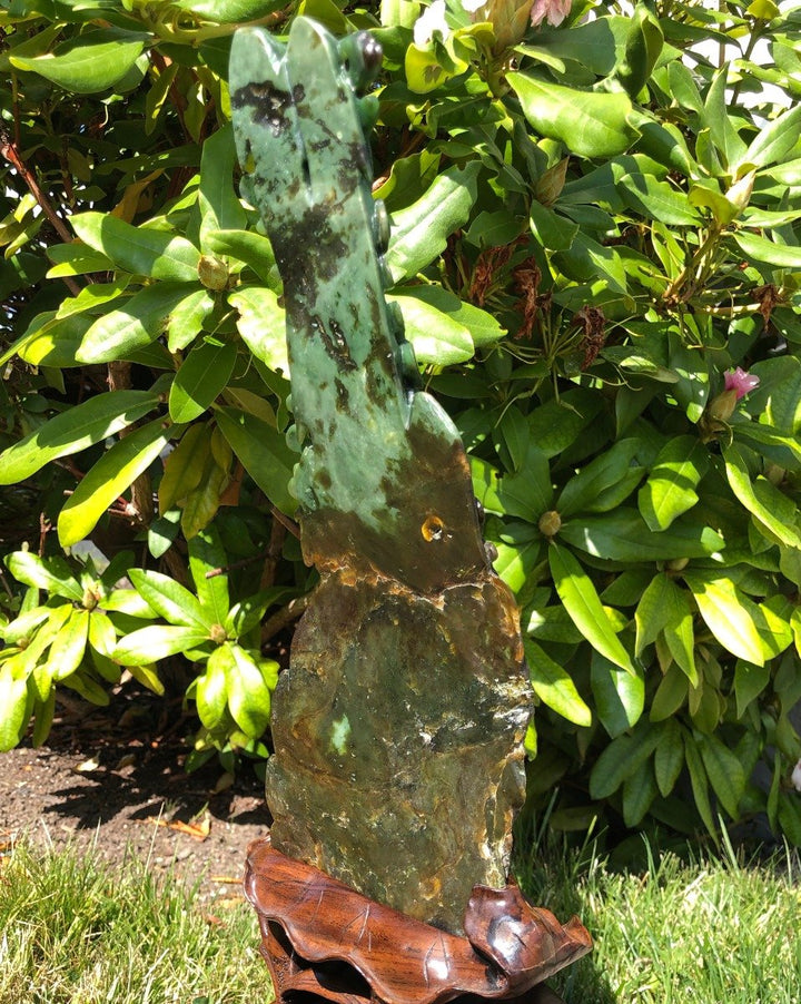 Rear angle of Jade Dragon Statue featuring a green jade slab and carved dragon atop a rugged rock base