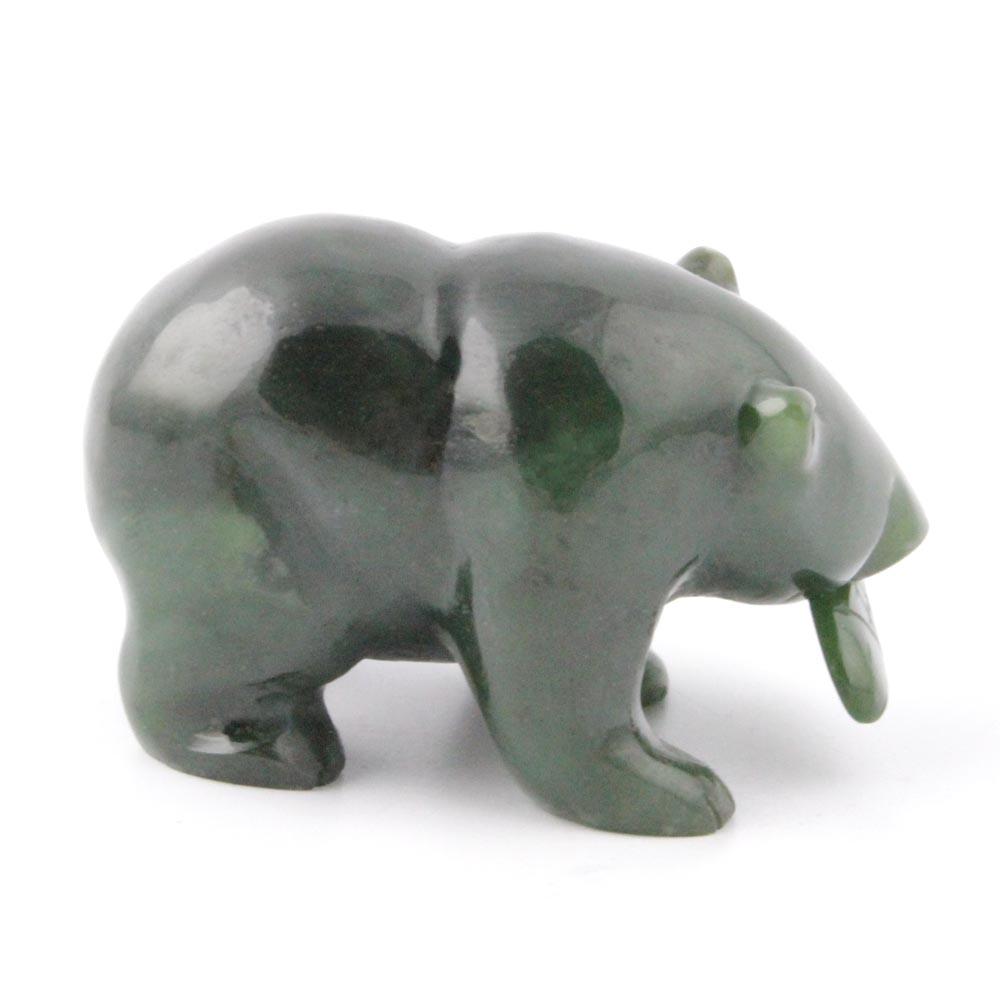 Dark green bear figurine with a fish in its mouth