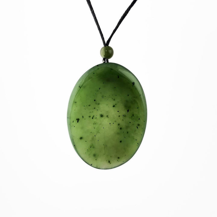 Green Jade Pendant on a black cord with a jade bead on top, white background