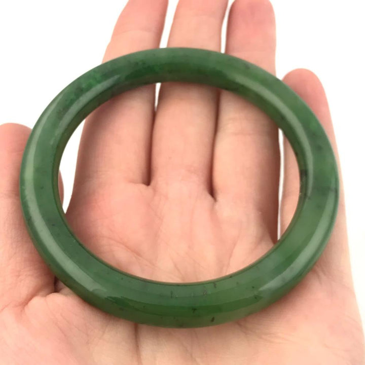 Canadian jade round bangle held in an open hand
