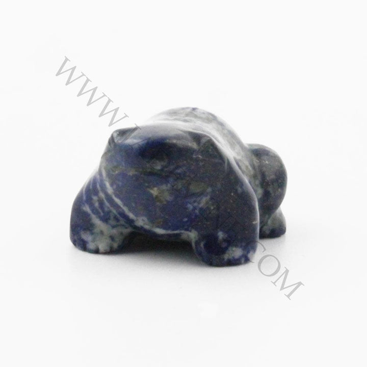 Blue lapis frog carving with white veining on a white background