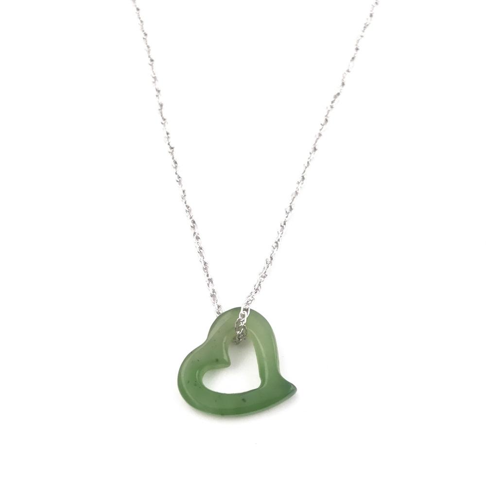 Green jade heart on a silver chain, white background