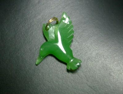 Green hummingbird pendant with a small loop for a chain.