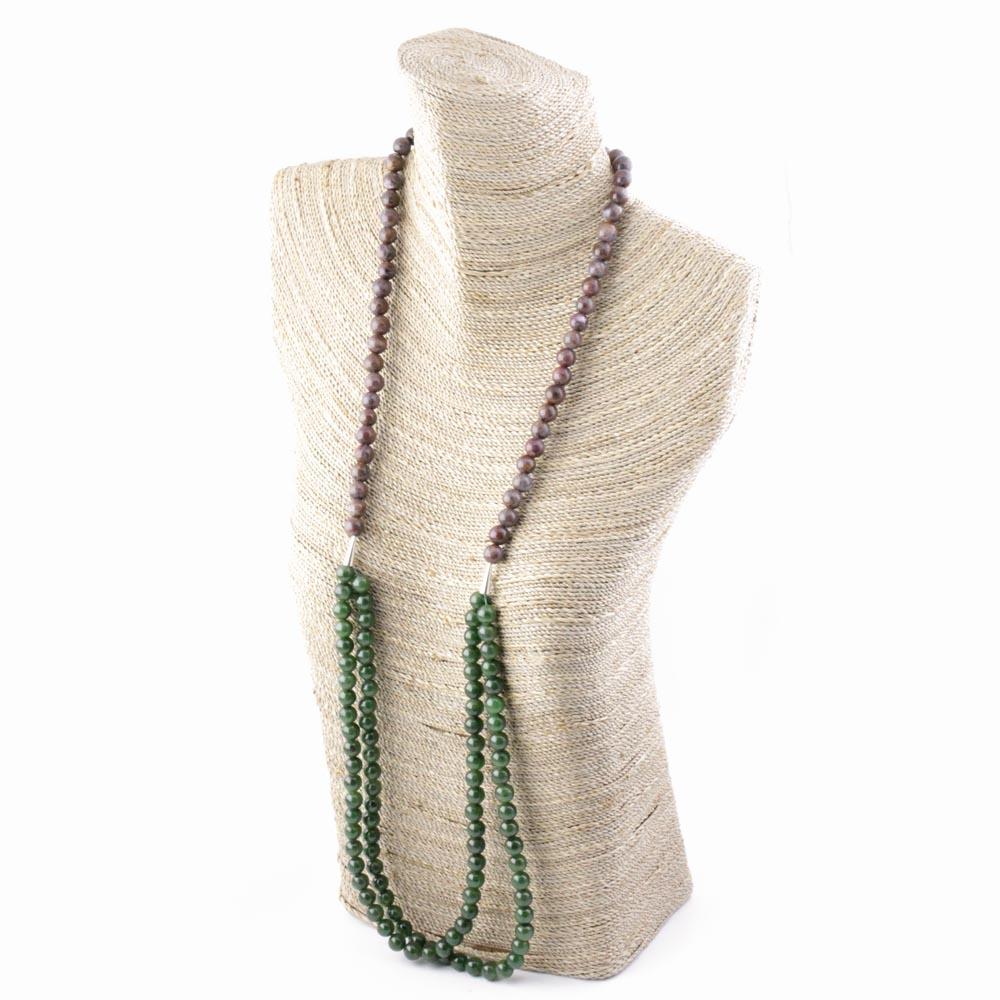 Jade bead and pietersite necklace displayed on a woven bust with purple pietersite beads above and green jade strands below