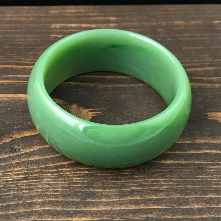 AA Siberian Bangle viewed from above highlighting the rounded exterior and inner hollow on wood