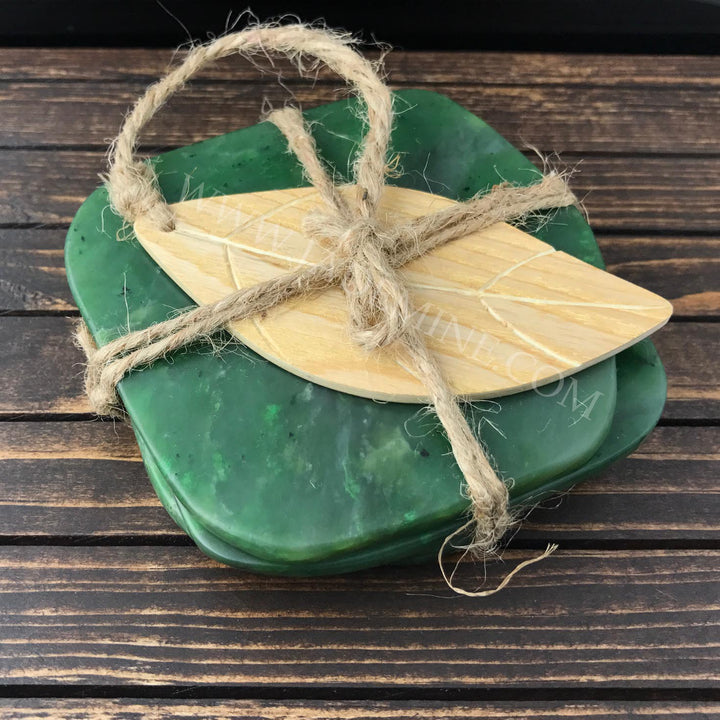 Green jade coasters tied with rustic twine and a wooden leaf shaped accent on top