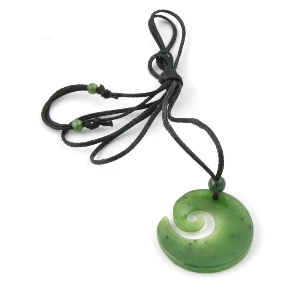 Green jade Spiral on a a black wax cord, with a white backround
