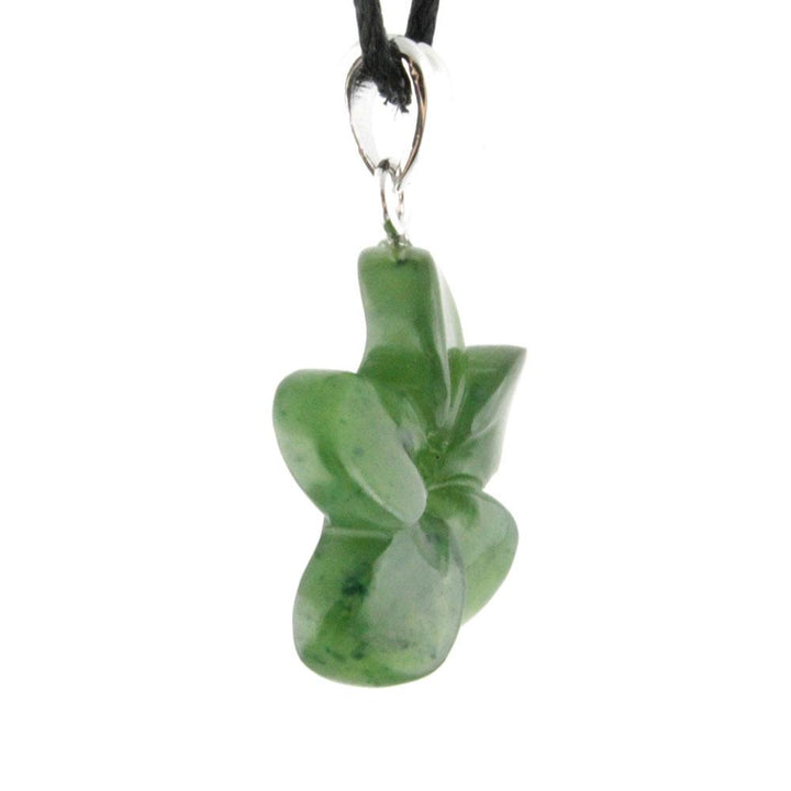 Side view of green jade flower pendant showing depth with a silver bail and black cord