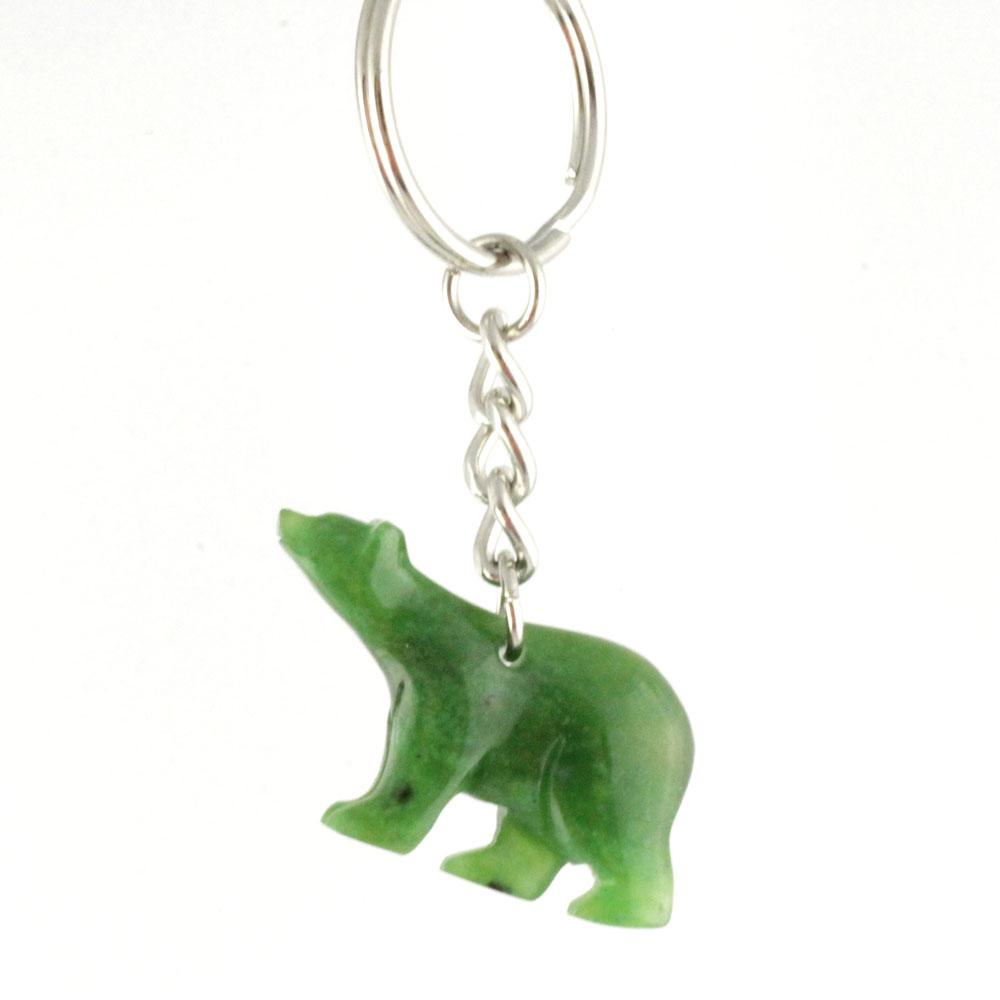 Green polar bear charm hanging from a silver linked chain on a keychain.