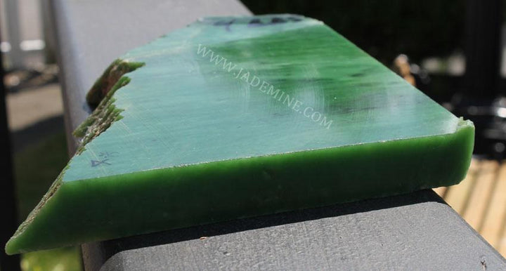 Triangular AA Siberian Rough jade block with a smooth top and rugged edges