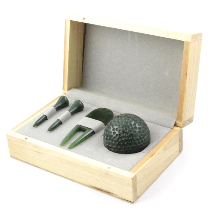 Golf tee box set with ball in a light wood box, featuring three green tees and a textured green golf ball.