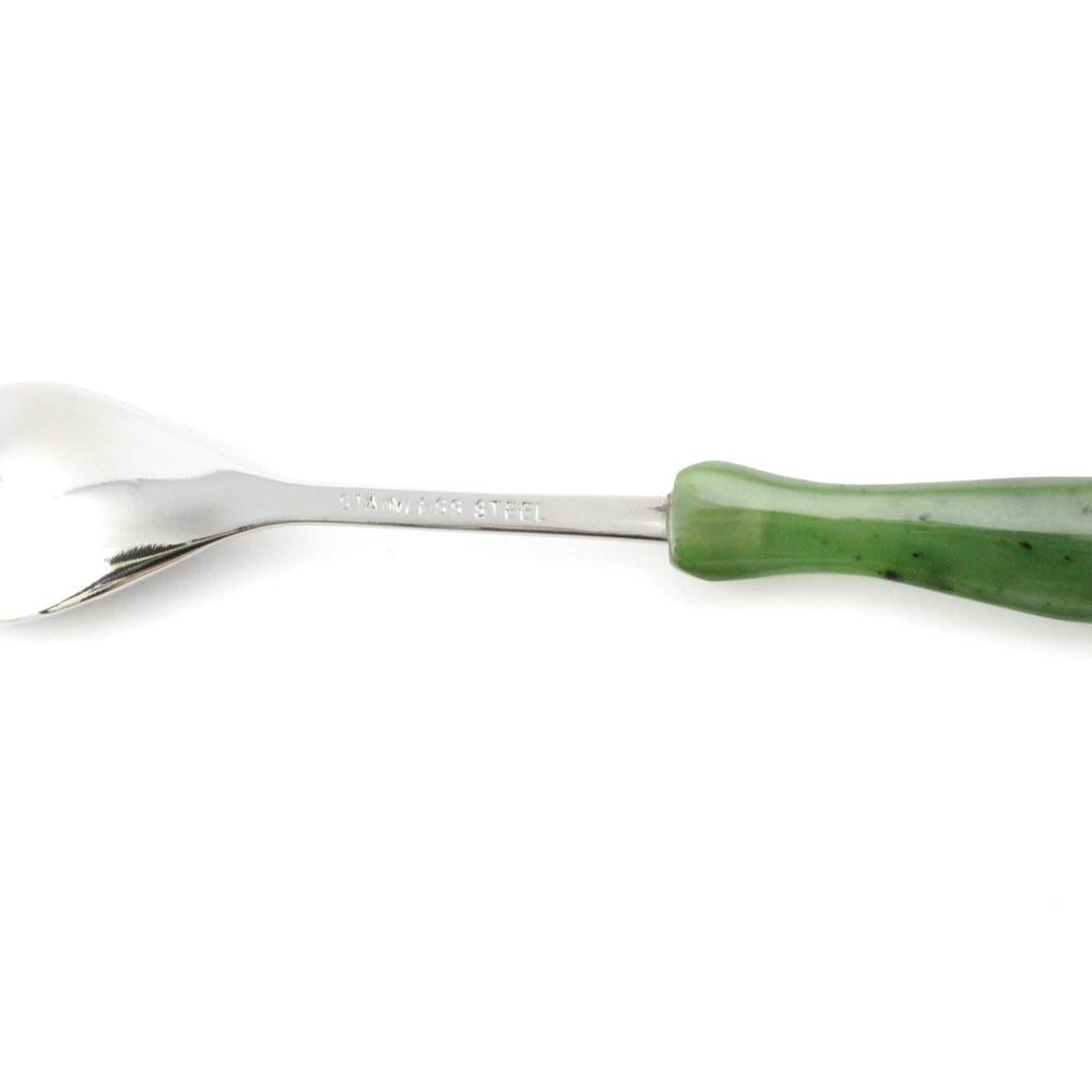 Side view of Jade sugar spoon with a glossy silver bowl and green handle