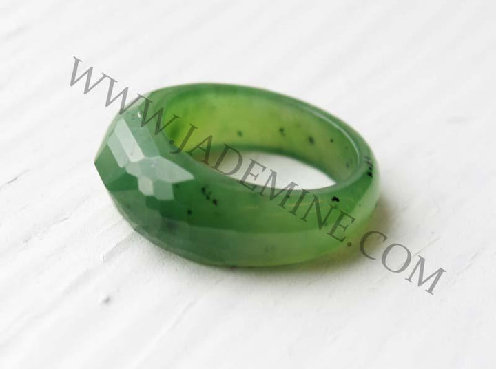 Green jade like faceted band ring with a glossy finish.
