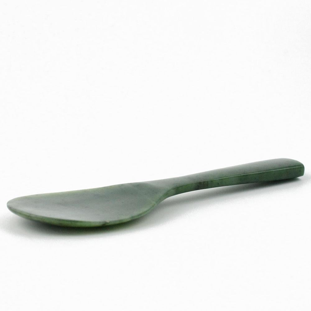 Eight inch jade rice spoon with a smooth curved handle on a white background.