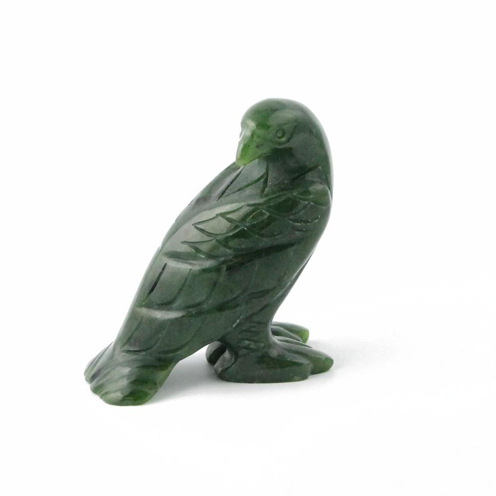 Green jade eagle sculpture standing on a base.