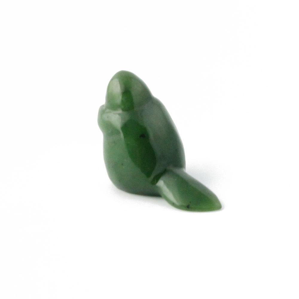 Green beaver figurine shown from the side with its tail visible
