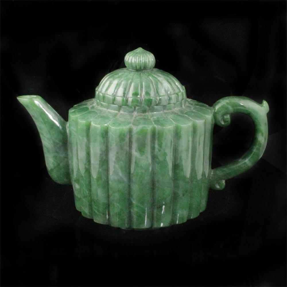 Jade teapot side profile with spout on the left and curved handle on the right
