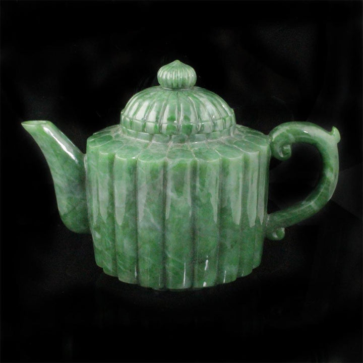 Jade teapot side profile with spout on the left and curved handle on the right