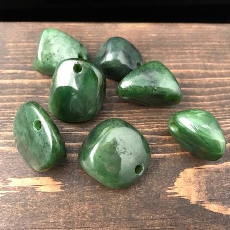 Green jade nugget beads with holes drilled for jewelry making.