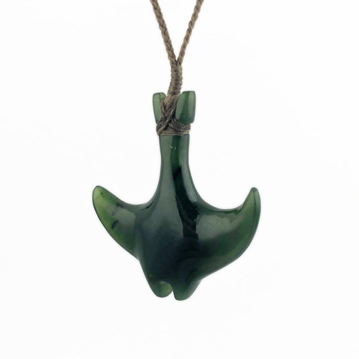 Dark green manta ray shaped pendant on a braided brown cord