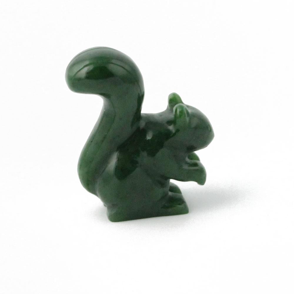 Side view of a dark green 1.5 inch squirrel figurine standing on hind legs with tail arched over its back