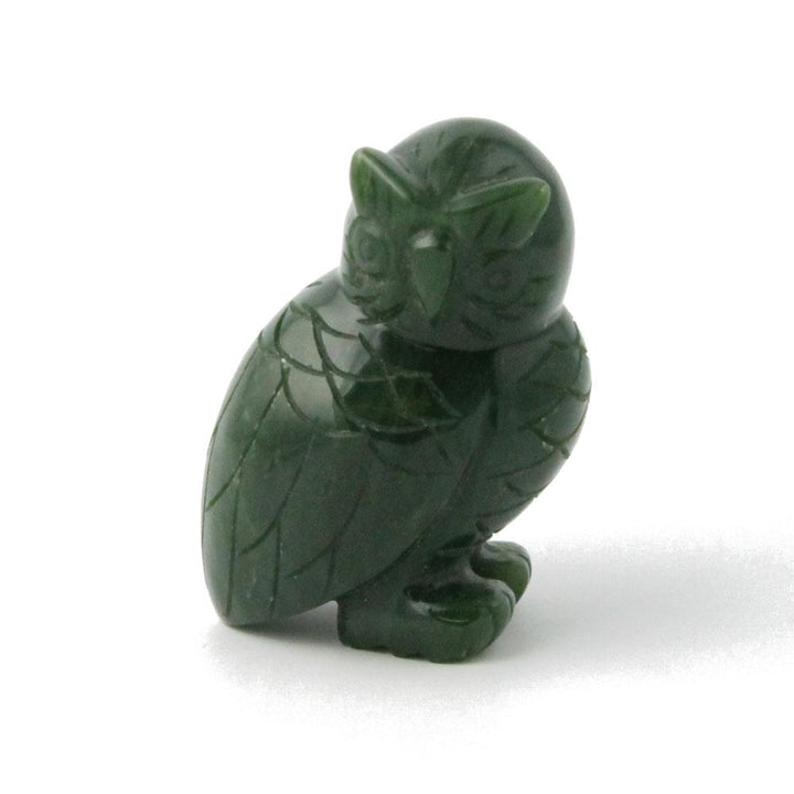 Dark green jade owl figurine with carved feather patterns and rounded body.