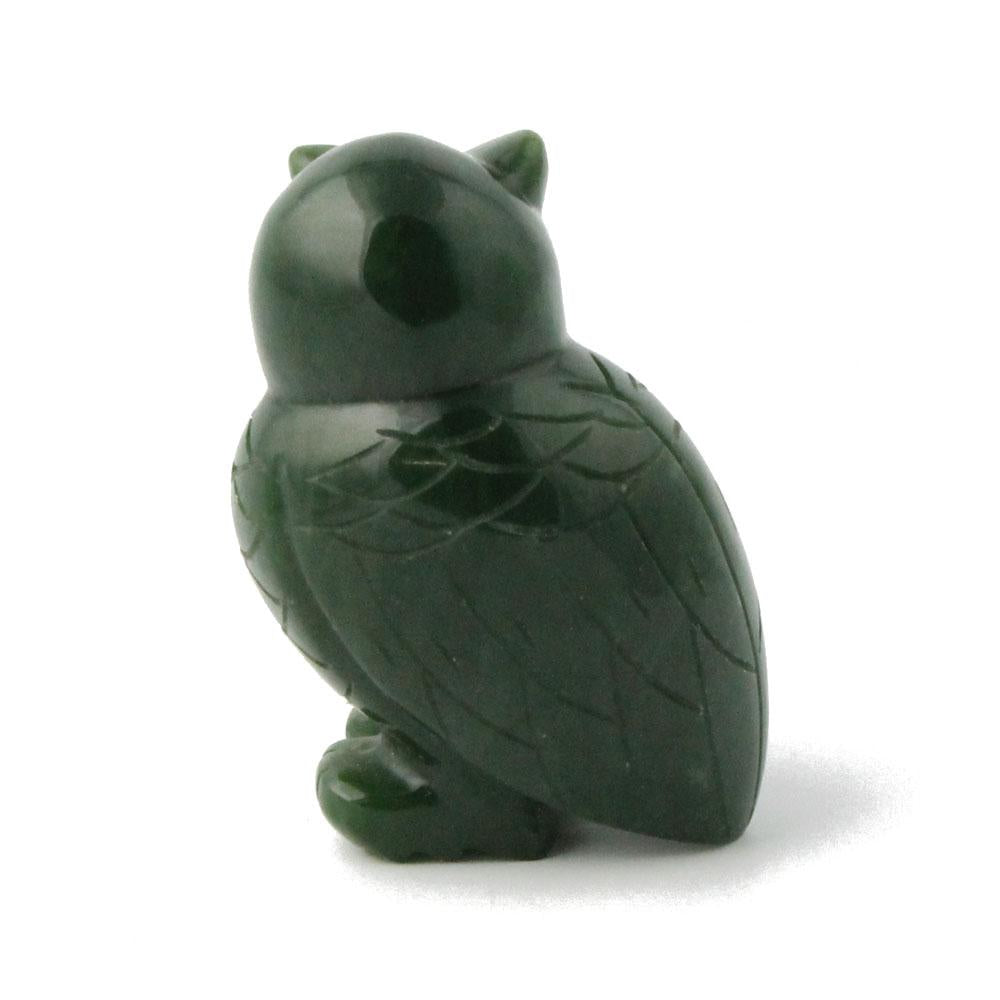 Dark green owl figurine with carved feather details in profile.