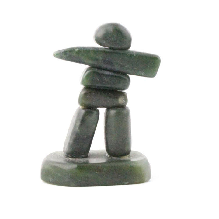 Green jade inukshuk on white background