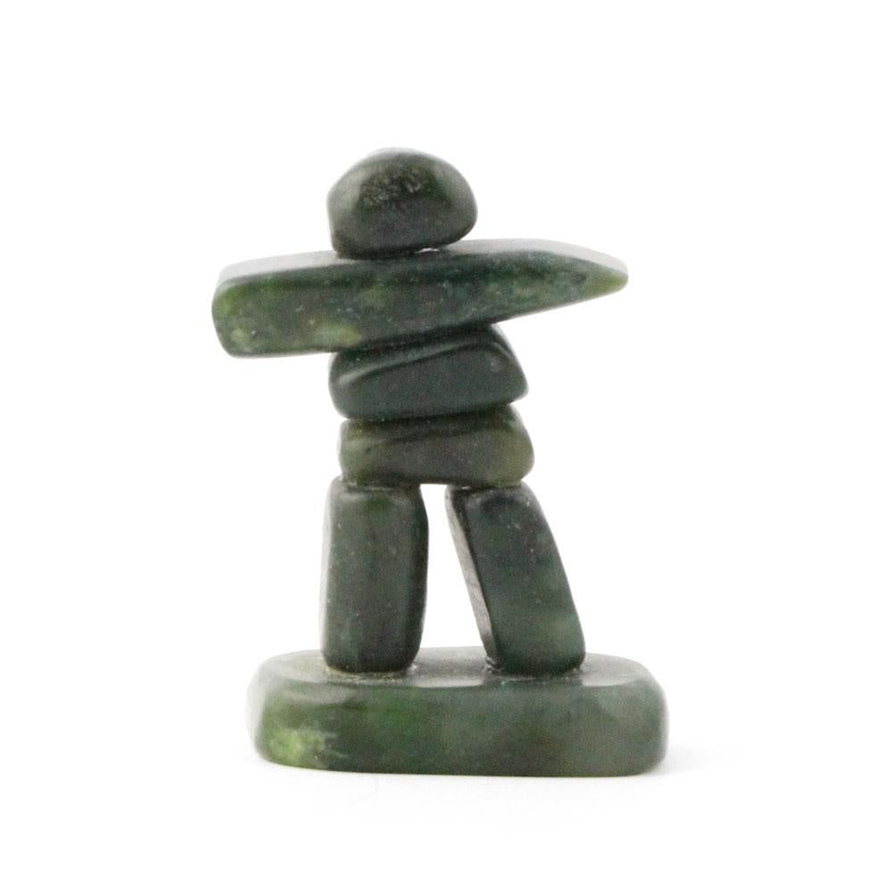 Small green stone Inukshuk with a horizontal rock arm and a rounded head.