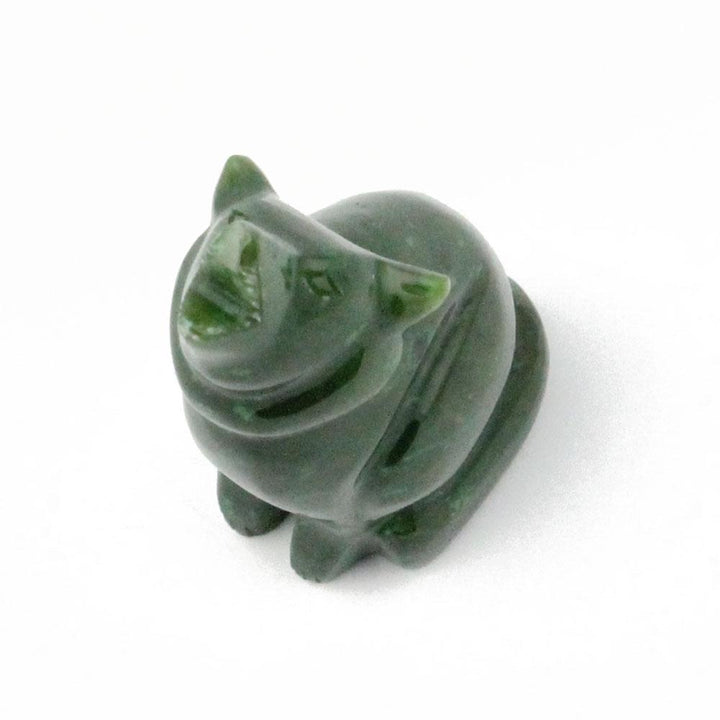 Small green jade wolf figurine carved from stone on white background