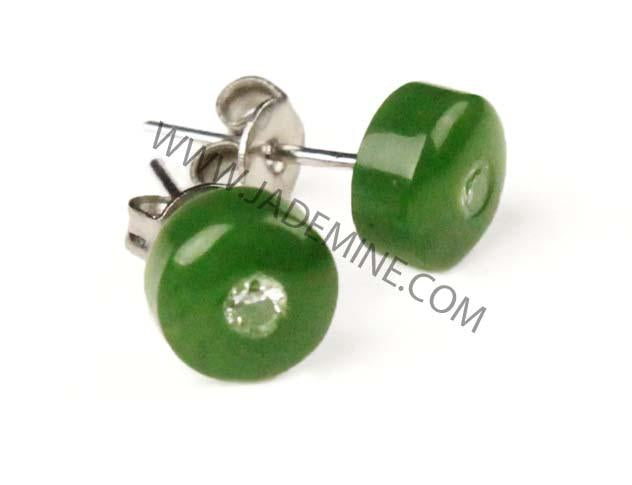 Side view of emerald-green round stud earrings with silver posts and backs