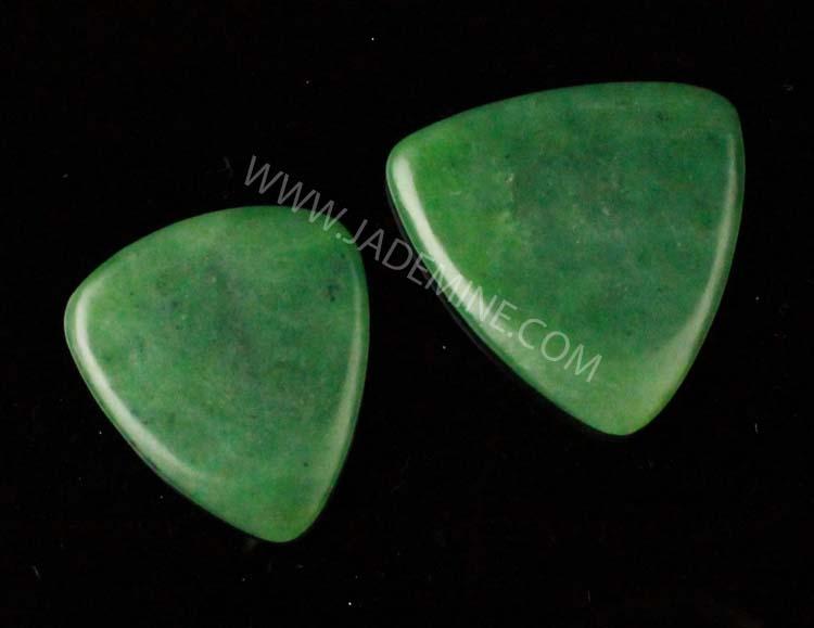 Green Jade Guitar Picks on a black background