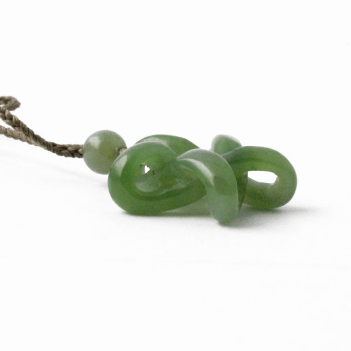 Green jade bead necklace with glossy round beads arranged along the strand.