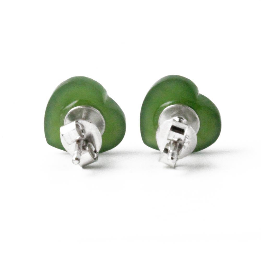 Two green jade heart stud earrings shown from a side angle with posts visible